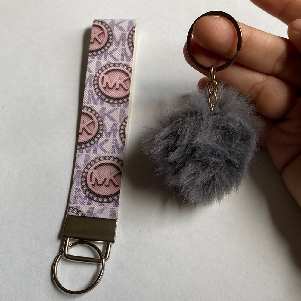 Michael Kors wristlet with a mini pom-pom